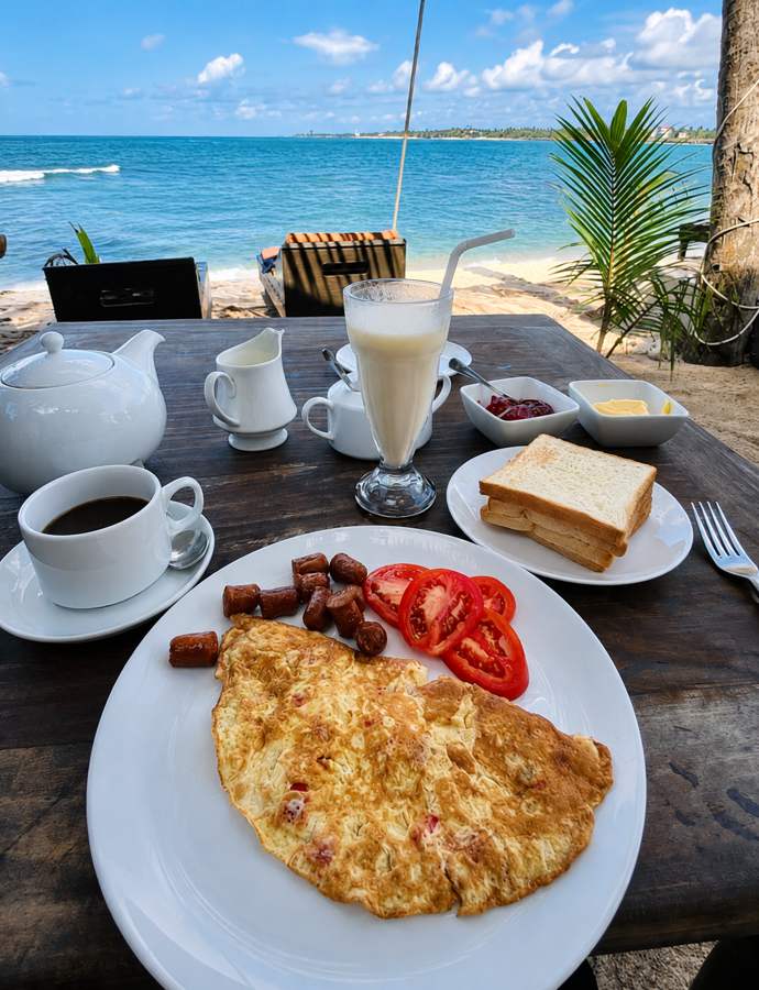 Breakfast served at a wooden table facing the sea