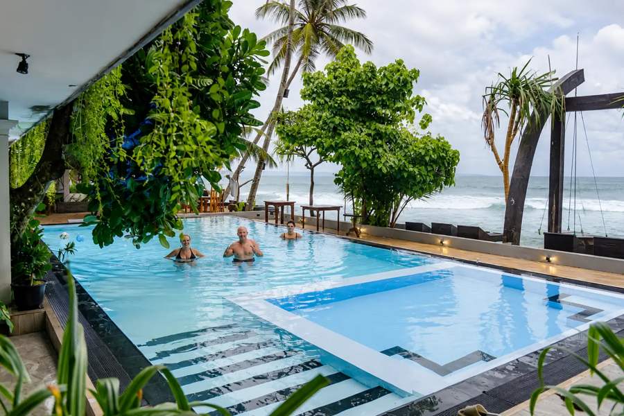 Outdoor pool beside the shoreline at Cool Beach Hotel